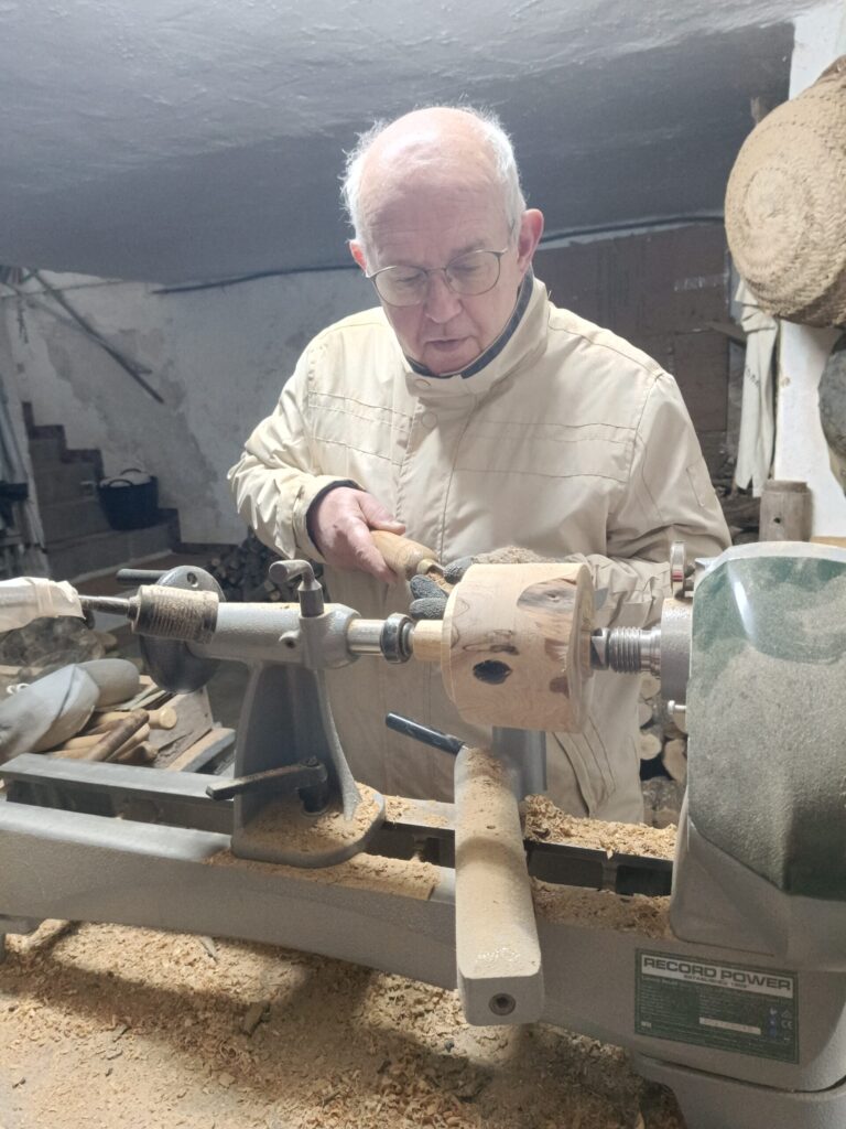 Harvey from Turned Around creating handcrafted wooden products on his lathe at home